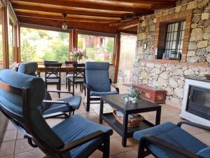 a living room with chairs and a fireplace at Casa Motta Camastra, panoramahouses, prive zwembad en prachtige vergezichten in Linguaglossa