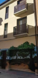 un edificio con una pintura de árboles a su lado en Apartamentos Picasso, en Alcalá de Henares