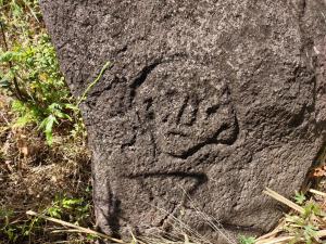 a rock with a face carved on it at Finca Mystica in Mérida