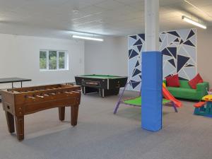 a room with a pool table and a ping pong table at Barn Owl in Ipplepen