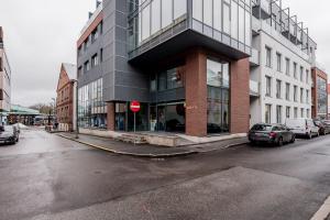 a red stop sign in front of a building at Heart of Pärnu Living - Contemporary 2 Bedroom Apartment with Balcony & Parking in Pärnu