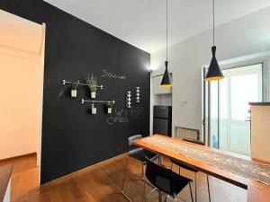 une salle à manger avec un mur noir et une table dans l'établissement Soleluna, à Catane