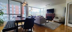 uma sala de jantar com uma mesa e uma sala de estar com um sofá em Corazon Oasis by IRIS PROPERTIES! em Victoria