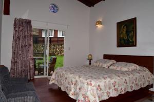 a bedroom with a bed and a sliding glass door at Condominio Hacienda Shangrila in San Francisco