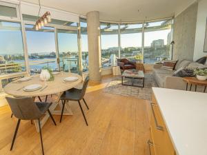 a kitchen and living room with a table and chairs at Janion Sky by IRIS PROPERTIES! in Victoria