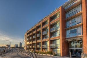 a red brick building with a street in front of it at Janion Sky by IRIS PROPERTIES! in Victoria