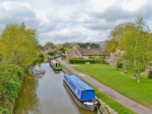 a boat on a river in a village at The Old Stable in West Pennard