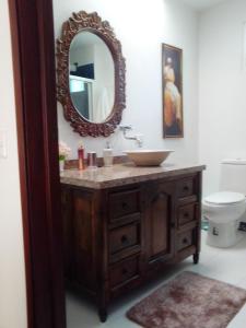 a bathroom with a sink and a mirror on the wall at Condominio Hacienda Shangrila in San Francisco
