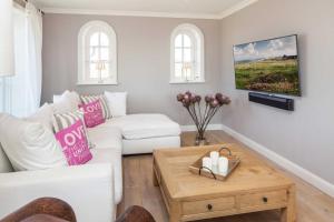 a living room with a white couch and a table at Beachalm in List