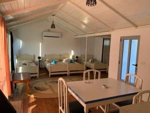a living room with a table and a room with a couch at CasaDolceCasa in Shkodër