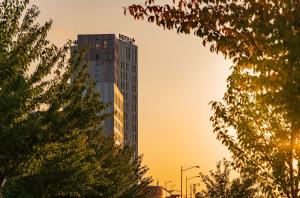 a tall building with the sunset in the background at Best Western Malmo Arena Hotel in Malmö