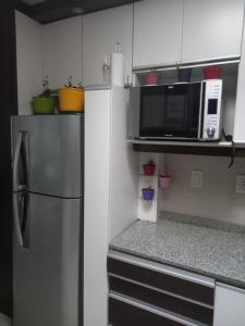 a kitchen with a refrigerator and a microwave at Mendoza is life in Guaymallen