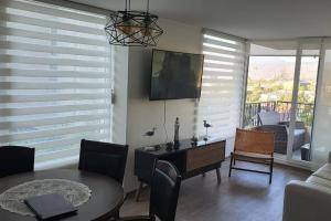 a living room with a table and a dining room at Papudo, Chile in Papudo
