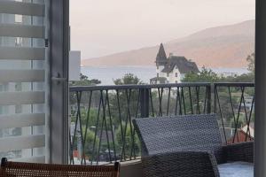 a balcony with a view of the water and a church at Papudo, Chile in Papudo