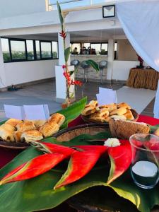 a table topped with baskets of bread and pastries at Le Majestic Toamasina Hotel in Toamasina