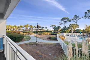 a view of the pool from the balcony of a house at Ocean Dunes Villas Coligny Beach 43 S Forest Beach Dr, Hilton Head SC #111 Heated Pool Ocean View By Vacation Rental HHI LLC in Hilton Head Island