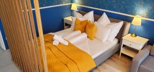 a bedroom with a bunk bed with white and yellow pillows at DN Blue Apartment in Budapest +19 photos
