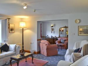 a living room with a couch and chairs and a table at Ty Newydd in Beddgelert