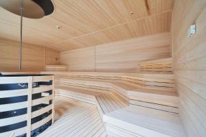 a sauna with wooden floors and a wooden ceiling at Yuuyu No Sato Yusa in Yamagata