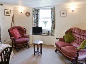 a living room with two couches and a tv at Wetherlam - E3829 in Lowick Green