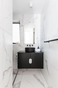 a bathroom with a black sink and a mirror at One Marola is stylish privacy in paradise in Noosa Heads