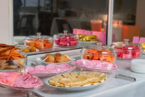 a buffet filled with different types of food on a table at Hostal Ibiza in Santa Cruz de la Sierra