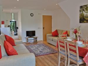 a living room with a couch and a table at Romany in Fletching