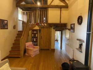 a living room with wooden floors and a wooden staircase at Finkle Barn in Fryup