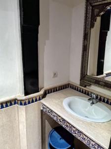 a bathroom with a sink and a mirror at Apartments Babylone 2 Marrakech in Marrakesh