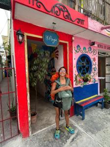 a woman standing in front of a building at Mi Refugio Dive House in Cozumel
