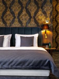 1 dormitorio con 1 cama con una pared azul y dorada en Old Market Residence, en Cracovia