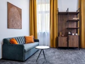 a living room with a blue couch and a table at Old Market Residence in Krakow