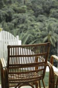 a wooden bench sitting next to a white fence at El Nido Bayview Resort in El Nido