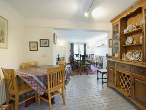 a kitchen and dining room with a table and chairs at Fernlea in Langton Matravers