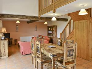 a living room with a wooden table and chairs at Sorrel - E4321 in Ludham