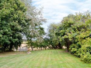 a large yard with trees and a grass field at The Stable-e2836 in Whitminster