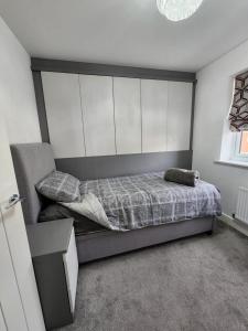 - une chambre avec un lit doté d'une grande tête de lit dans l'établissement Spacious 3-bed Luxury Maidstone Kent Home - Wi-Fi & Parking, à Kent