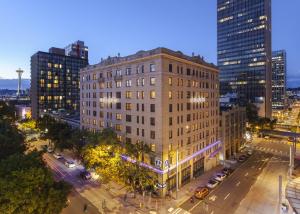 an aerial view of a building in a city at night at Hotel Andra Seattle MGallery Hotel Collection in Seattle