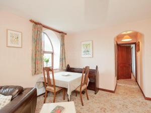 a living room with a table and a couch at The Old Chapel in Hury