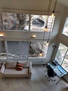 a living room with a couch and some windows at Koba, una experiencia memorable in Potrero de los Funes