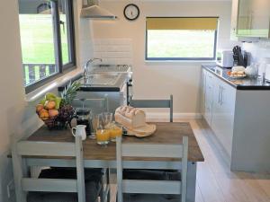 a kitchen with a wooden table with fruit on it at Bluebell Lodge - Uk13449 in Halwill