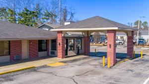 a brick building with a pavilion in a parking lot at Travelodge by Wyndham Jackson I-40 Exit 82 in Jackson