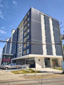a large building on the corner of a street at Departamento estudio3 IslaTeja in Valdivia