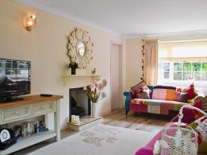 a living room with a couch and a fire place at Captains Cottage - 27888 in Winterton-on-Sea