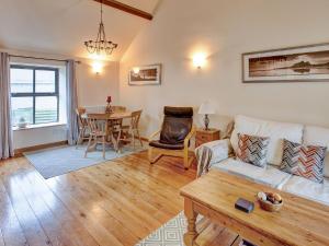 a living room with a couch and a table at Corn Cottage in Fenham