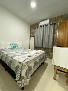 a bedroom with a bed and a air conditioner at Conchas de Maragogi in Maragogi