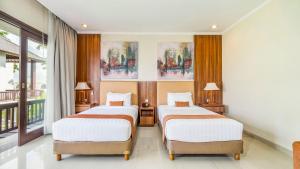 two beds in a room with two windows at Sotis Villas Canggu in Canggu
