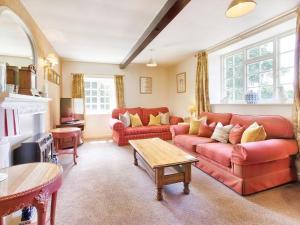 a living room with two red couches and a table at Carriage House - E5119 in West Burton