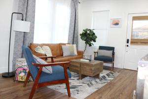 a living room with a couch and two chairs at 3 Bedroom Modern Ybor City Home- Pet Friendly in Tampa
