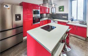 a kitchen with red cabinets and a white counter top at Lovely Home In Laurens in Laurens